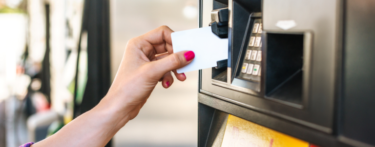 Hand with card paying fuel