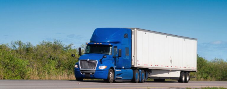 blue truck driving down the highway